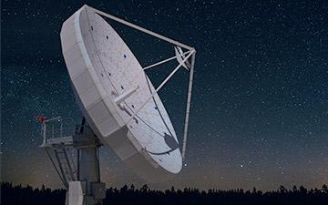 White ground satellite antenna against a starry night sky